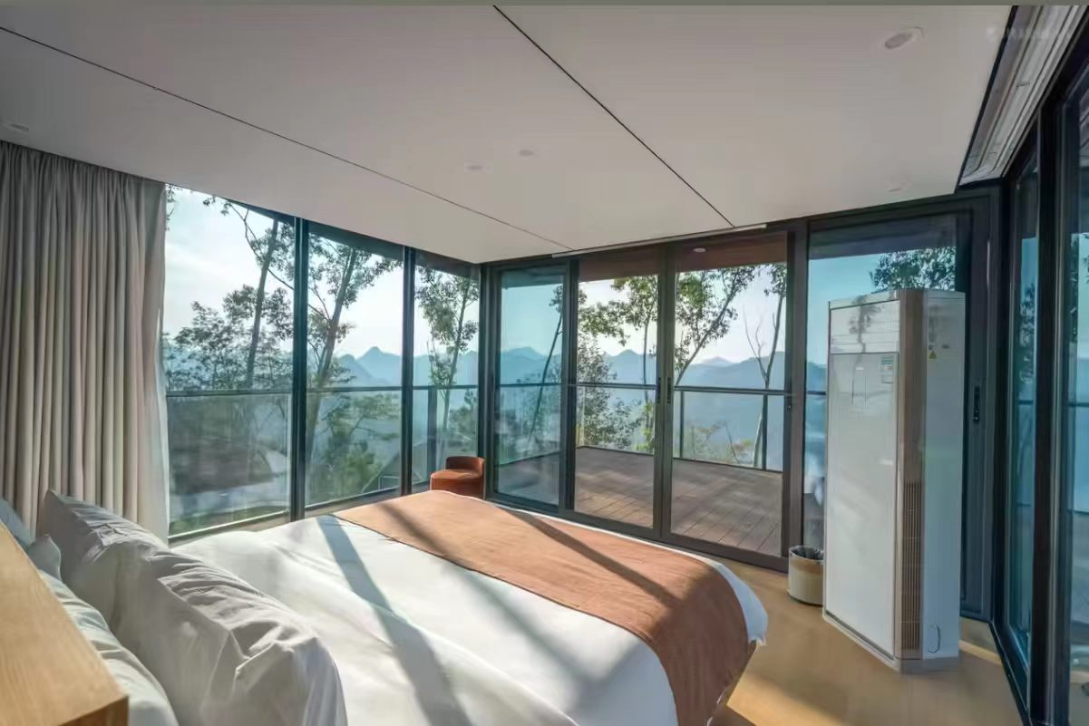 Finished bedroom with windows and mountain view