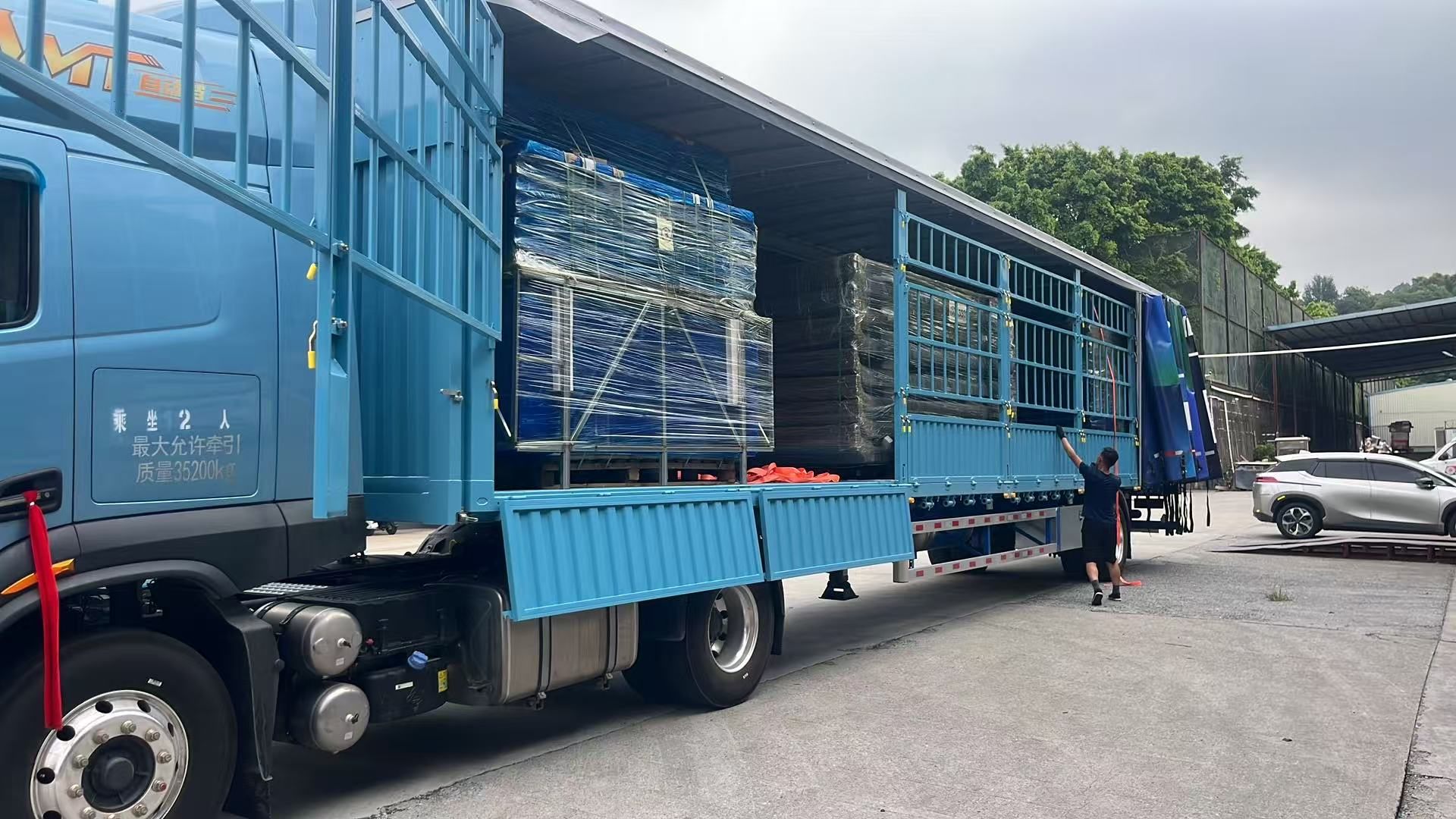 Packed prefab building unit loaded on a flatbed delivery truck