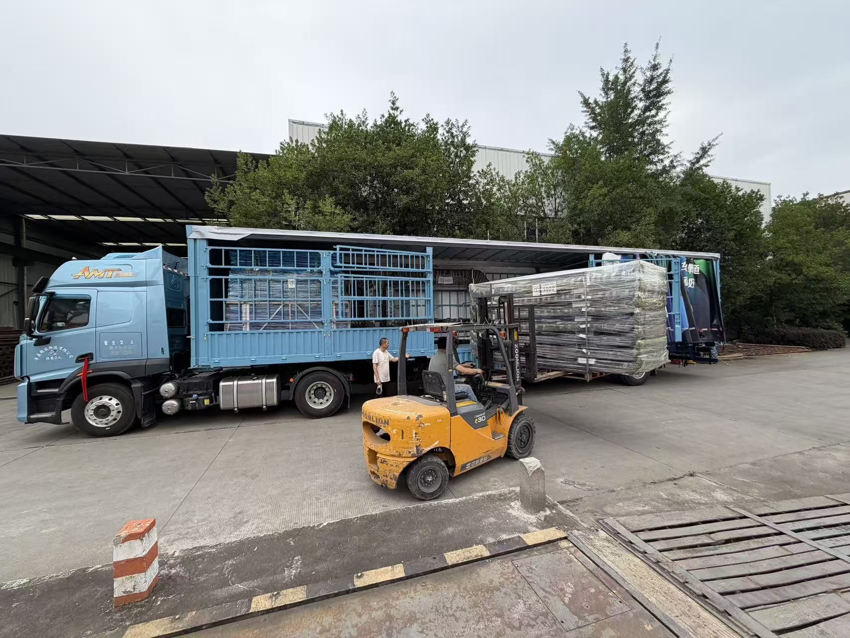 Forklift handling packed prefab building components at the factory