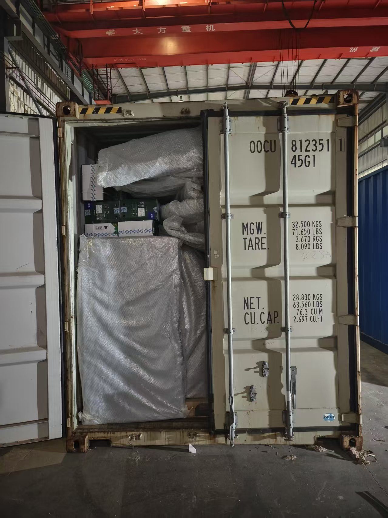 Prefab cabin components loaded inside a shipping container